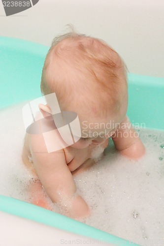 Image of little baby takes a bath