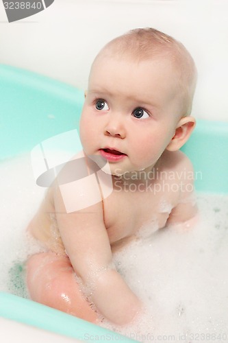Image of little baby takes a bath