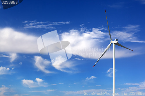 Image of Wind turbine and blue sky with clouds