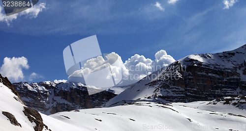 Image of Panoramic view on snow rocks and cloudy blue sky