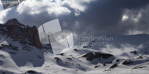 Image of Panoramic view on snowy mountains in storm clouds