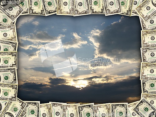 Image of Frame from the dollars on evening sky background