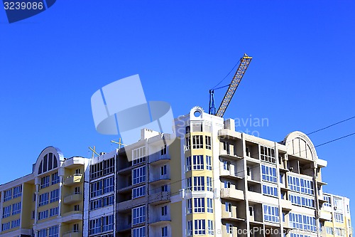 Image of modern skyscraper with hoisting crane