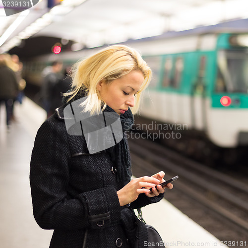 Image of Woman on a subway station.