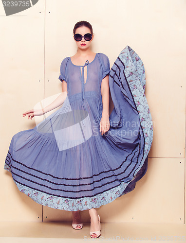 Image of Full body slim woman in blue sundress