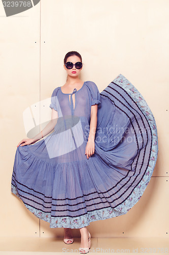 Image of Full body slim woman in blue sundress