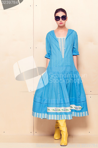 Image of Full-length portrait woman in romantic dress on wodden background