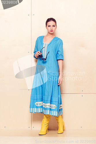 Image of Full-length portrait woman in romantic dress on wodden background