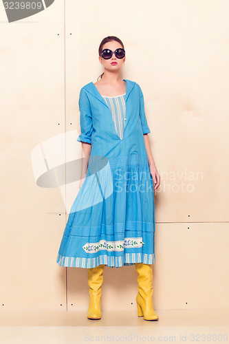 Image of Full-length portrait woman in romantic dress on wodden background