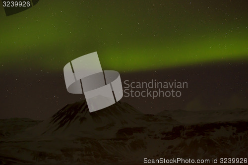 Image of Northern lights with snowy mountains in the foreground