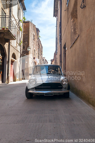 Image of old retro car in a narrow streets of the city