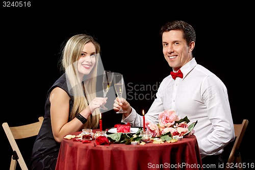 Image of Portrait Of Romantic Couple Toasting white Wine At Dinner