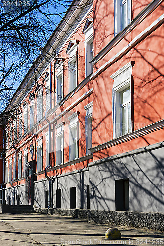 Image of Facade of old red building with architectural decorations