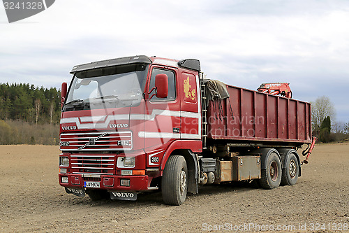 Image of Early Red Volvo FH12 Truck Parked on a Field