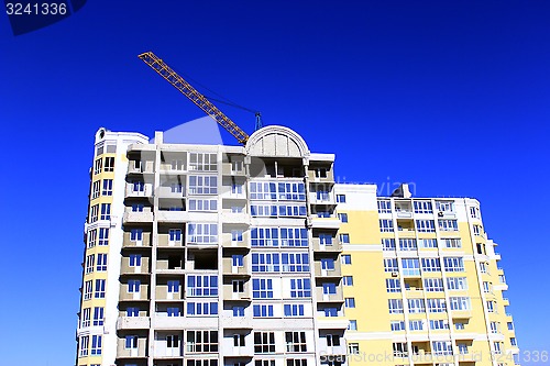 Image of modern skyscraper with hoisting crane