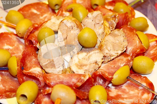 Image of meat cutting into pieces and olives