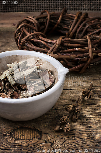 Image of licorice rolled in coil on wooden background