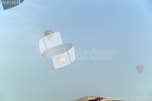 Image of three hot air balloons in the fog