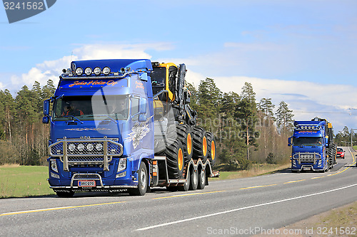 Image of Two Volvo FH Trucks Haul Ponsse Forestry Machinery