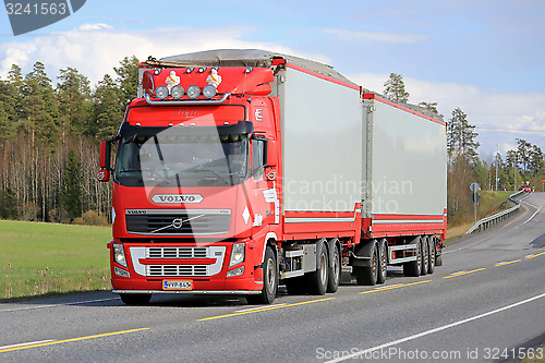 Image of Red Volvo FH Full Trailer Truck on the Road