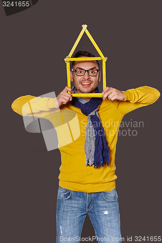 Image of Man showing house frame concept