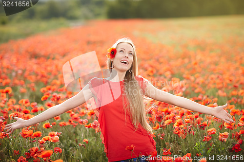 Image of Happy woman on poppy flower field