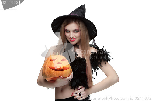 Image of Girl in witch costume with Halloween pumpkin