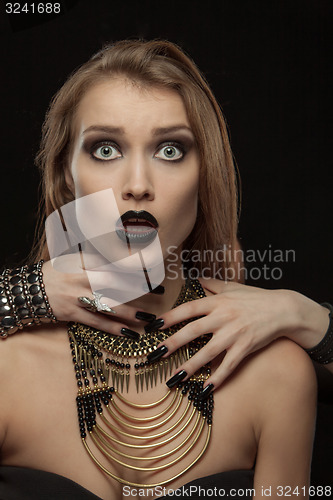 Image of Gothic woman with hands of vampire on her neck