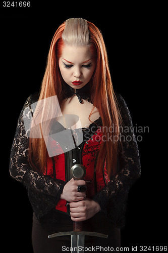 Image of Portrait of gorgeous redhead woman with long sword