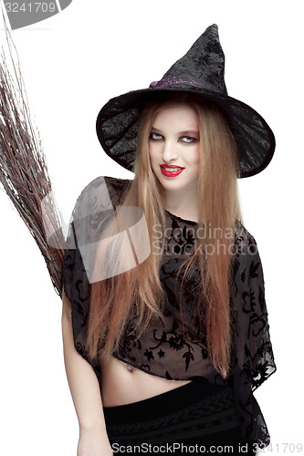 Image of Girl in witch costume with a broom 