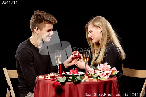 Image of Man proposing marriage to a surprised woman