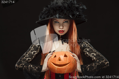 Image of Girl with Halloween pumpkin on black background