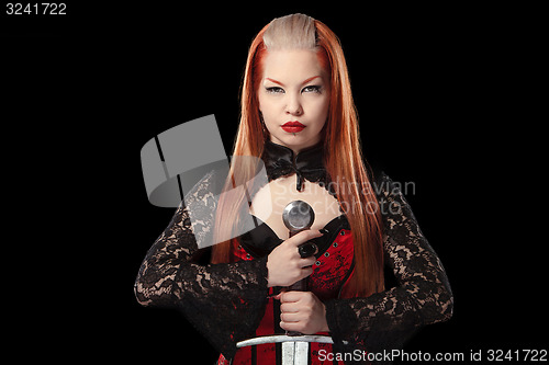 Image of Portrait of gorgeous redhead woman with long sword