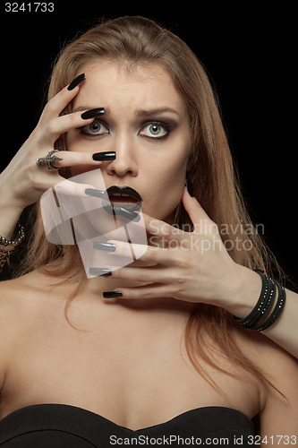 Image of Gothic woman with hands of vampire on her face. Halloween