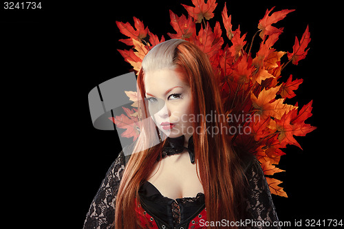 Image of Young woman with autumn maple leaves 