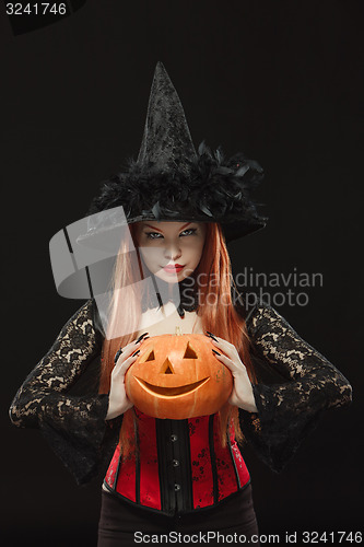 Image of Girl with Halloween pumpkin on black background