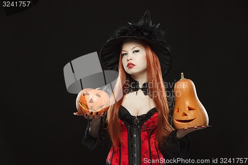 Image of Girl with two Halloween pumpkin on black background