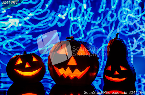Image of Halloween pumpkins on blue background