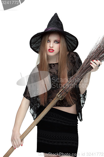 Image of Young girl in witch costume with a broom