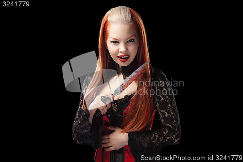 Image of attractive vampire with a bloody knife