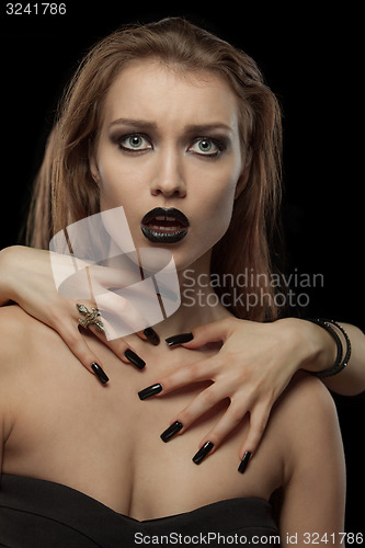 Image of Gothic  brunette woman with hands on neck