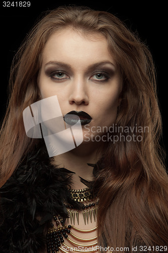 Image of Closeup portrait of a gothic femme fatale with black lips