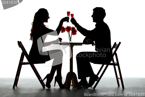 Image of Couple Having Dinner With Wine Glass On Table