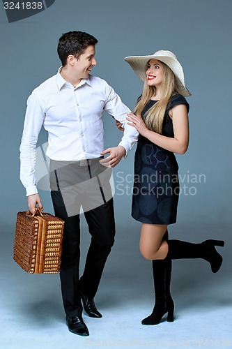 Image of Young Happy Couple Of Travelers With Bag