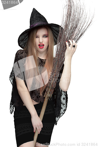 Image of Woman winking eye in witch costume with a broom 