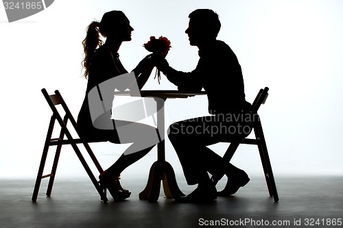 Image of Couple Having Dinner With Wine Glass On Table