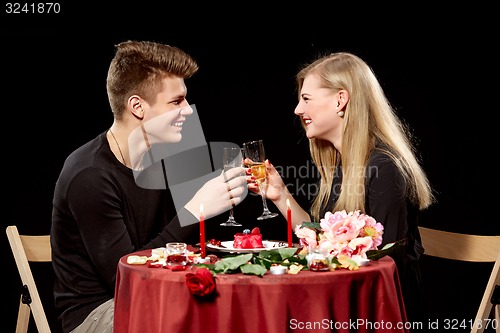 Image of Portrait Of Romantic Couple Toasting white Wine At Dinner