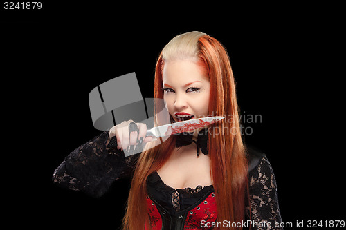 Image of attractive vampire with a bloody knife