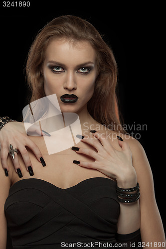 Image of Gothic woman with hands of vampire on her body. Halloween