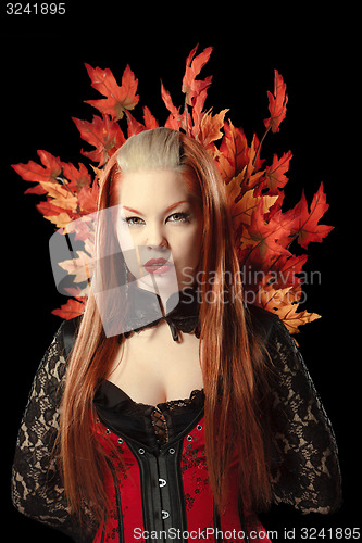 Image of Young woman with autumn maple leaves 